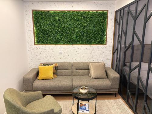 a living room with a couch and two chairs at Luki's Apartment in Pristina