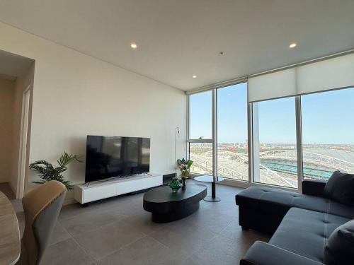 a living room with a flat screen tv and a couch at 2BR apartment close to Accor Stadium in Sydney