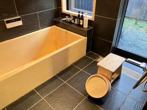 a bathroom with a toilet and a bath tub at 京一軒町家 さと居 鉄仙 SATOI TESSEN Omiya-Gojo in Kyoto