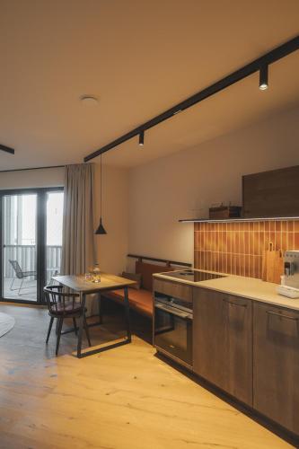 a kitchen with a table and a dining room at Agrad Chalets in Aschau im Chiemgau