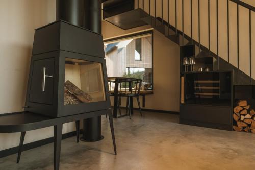 a fireplace in a living room with a staircase at Agrad Chalets in Aschau im Chiemgau