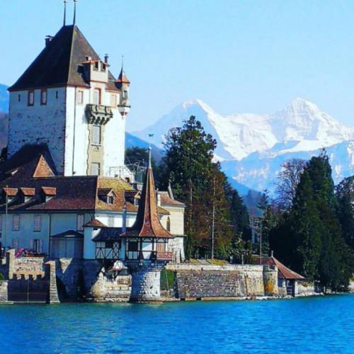 a building on the shore of a body of water at SwissHut Stunning Views Alps Lake - Apart. Staat 22 in Thun