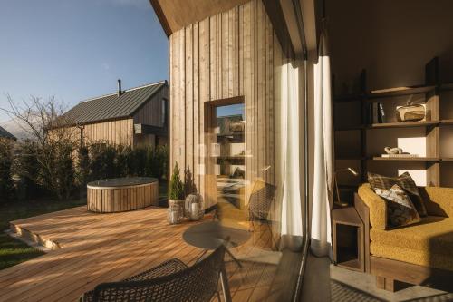 a patio with a hammock on a wooden deck at Agrad Chalets in Aschau im Chiemgau
