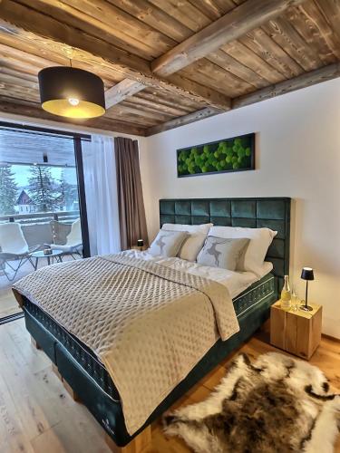 a bedroom with a large bed in a room at WOODHOME - Luxury Mountain Apartment Harrachov in Harrachov