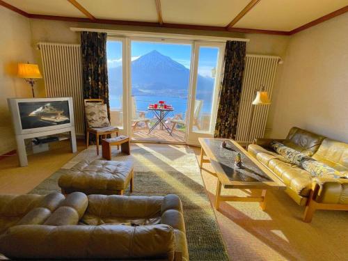 a living room with a view of a mountain at SwissHut Stunning Views Alps Lake - Apart. Molly in Sigriswil