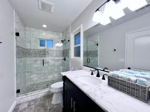 a bathroom with a sink and a shower and a toilet at Destination #28 in Anaheim
