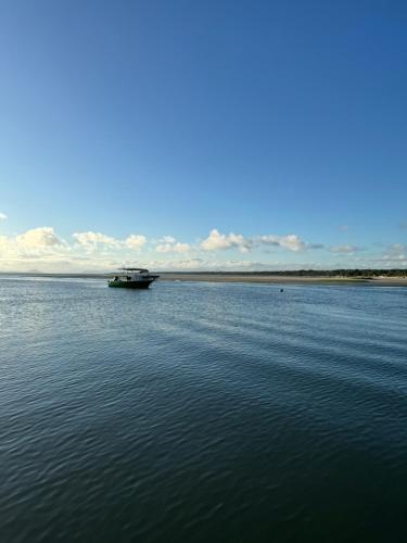 a boat in the middle of a large body of water at Pousada Bela Vista in Ilha do Mel