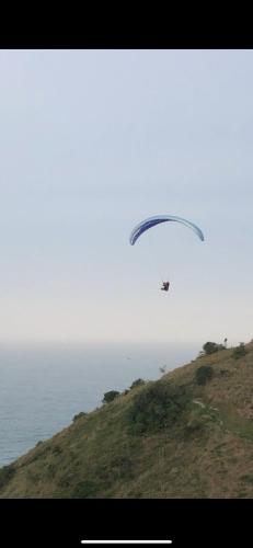 a kite flying in the sky over the ocean at Pousada Bela Vista in Ilha do Mel