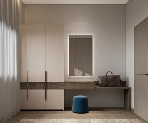 a room with a desk with a mirror and a blue stool at Liora ليورا in Riyadh