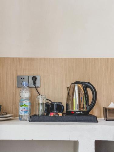 a counter top with a tea pot and a tea kettle at Arunika Villa in Ciloto