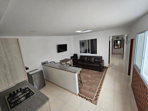a living room with a couch and a table in a room at APARTAHOTEL DON BELI in Salento