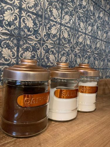 three jars of food sitting on a table at Antica Residenza degli Archi in Moncalvo