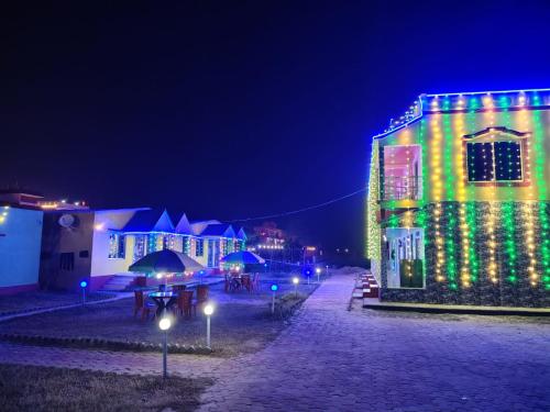 a building with christmas lights on it at night at Sea Smile Inn in Mandarmoni