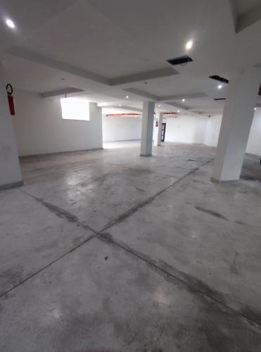 an empty parking garage with white walls and concrete floors at Hotel Movida in Casoria