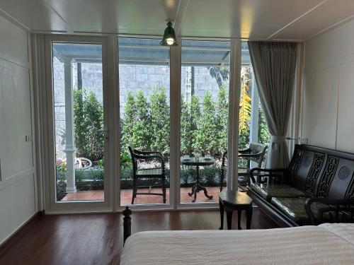a bedroom with a bed and a view of a patio at Baan Debtida in Bangkok