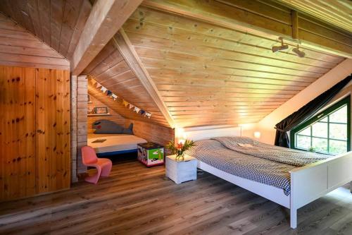 a bedroom with a large bed in a room with wooden walls at Fehmarn Ostseeferien Landliebe Fehmarn 117 in Fehmarn