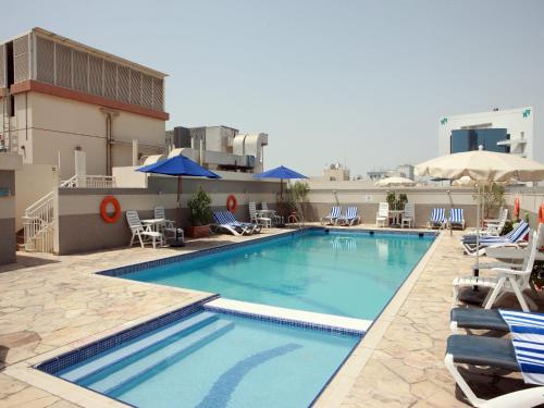a swimming pool on the roof of a hotel at Rose Garden Hotel Apartments - Bur Dubai in Dubai