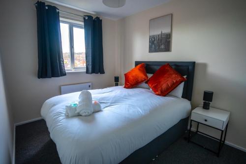 a bedroom with a bed with a stuffed animal on it at Anderson Apartment in Airdrie