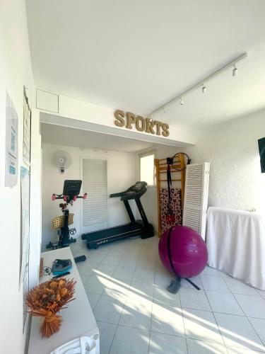 a fitness room with a gym with a treadmill at Hotel La Tuiliere in Carry-le-Rouet