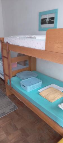 a bunk bed with a desk and a shelf at Luz de Regina Hospedagem in Salvador