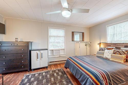 a bedroom with a bed and a dresser and a refrigerator at 3 Bears Cabin in Maggie Valley