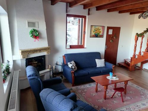 a living room with blue couches and a table at Apartments Holiday Home Srce in Kopaonik