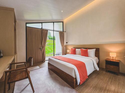 a bedroom with a large bed and a large window at Arunika Villa in Ciloto