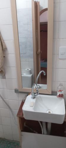 a bathroom with a sink and a mirror at Luz de Regina Hospedagem in Salvador