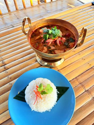 a bowl of soup and a plate of rice at Three Trees Samui Resort - Sarocha Villa in Lamai