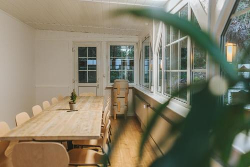 a room with a table and chairs and windows at Ferienhaus Waldtraum Winterberg in Winterberg