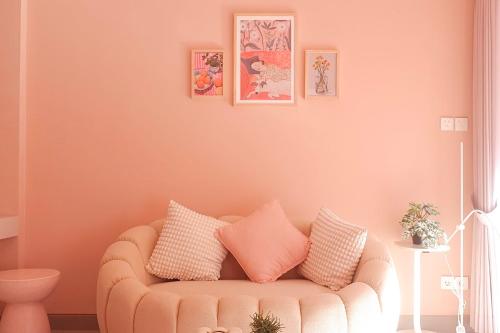 a living room with a couch with pillows on it at Ponder Bali Canggu in Canggu