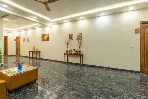 a room with white walls and a table at Lime Tree Hotel & One Bed Room Serviced Apartment - Noida Next to Sector 50 Metro with Party Venue in Noida