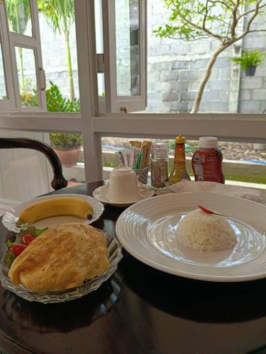 a table with plates of food on a table at Baan Debtida in Bangkok