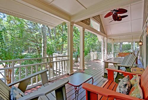 a screened in porch with chairs and tables on it at OG02: 2 Ocean Green in Kiawah Island
