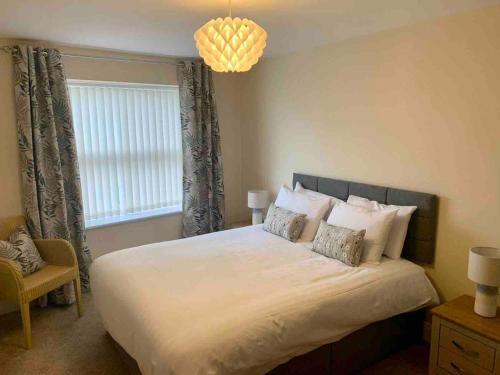 a bedroom with a large bed and a window at Modern 2 Bedroom Apartment with Sea view in Felixstowe