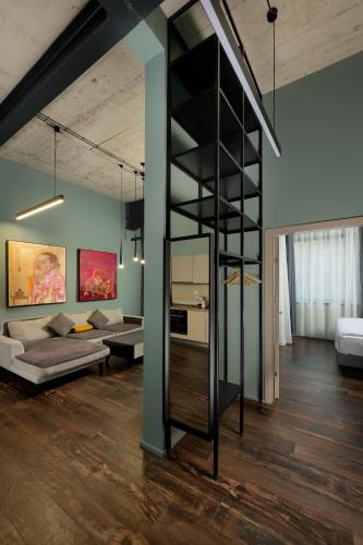 a living room with a black book shelf at ArtHomes Apartments in Timişoara
