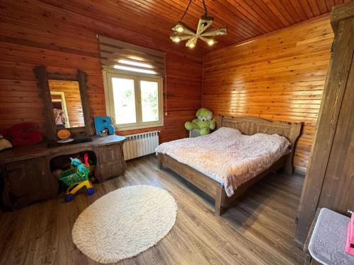 a bedroom with a bed in a wooden cabin at Shahdag wood house in Qusar