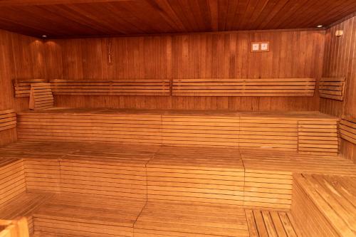 a large empty room with wooden walls and benches at Vulkán Wellness Hotel & Camping in Celldömölk