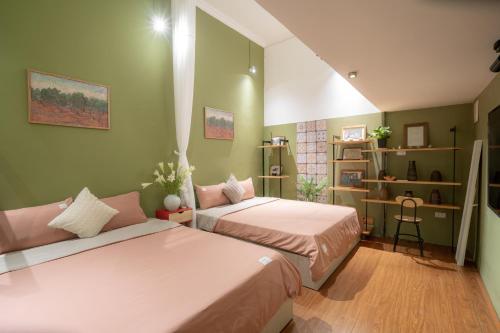 two beds in a room with green walls at Old Quarter 6 Senses 3Br Hoan Kiem in Hanoi