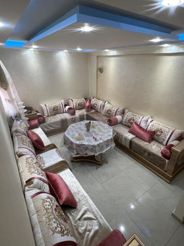 a living room with couches and a table at Residence arraha in Tangier