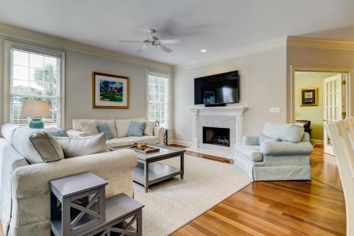a living room with a couch and a fireplace at GE317: 317 Glen Eagle in Kiawah Island