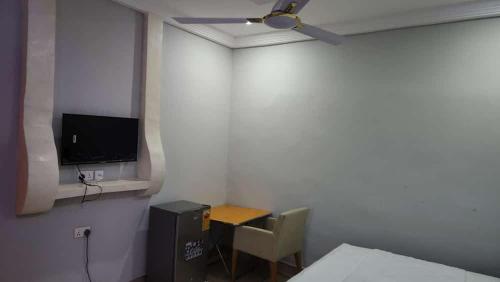 a small room with a small table and a television at Jakara Avenue Hotel- Tamale in Kyanshiogo