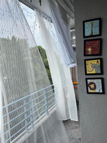 a window with white curtains in a room at Cosy Vista in Canacona