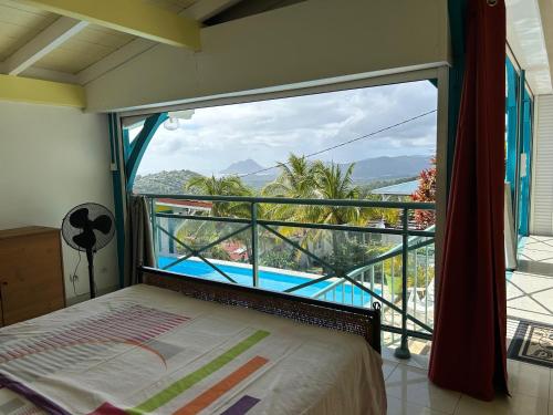 a bedroom with a large window with a view of a pool at Les marches de Paulina in Sainte-Luce