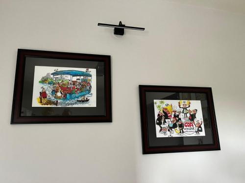 two framed pictures of a roller coaster on a wall at Cosy Vista in Canacona