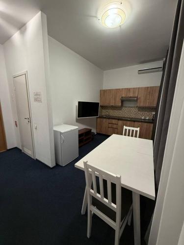 a room with a table and chairs and a kitchen at Biplan Hotel in Daugavpils