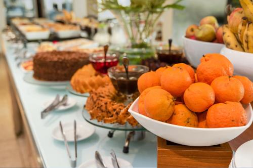 a buffet of food with oranges and other desserts at Hotel Brisa Praia Pajuçara in Maceió