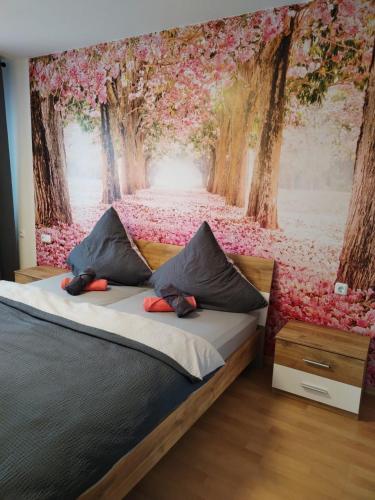 a bedroom with a wall mural of a forest filled with flowers at Naturblick in Baiersbronn