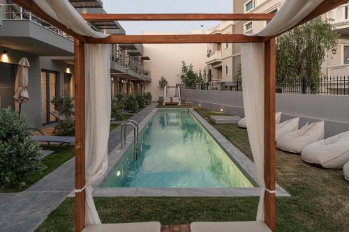 an outdoor swimming pool with a pergola at NEK Suites - Adults Only in Chania Town