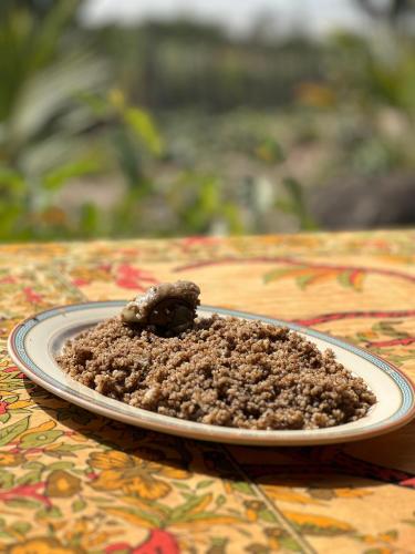 a plate of food sitting on a table at Mama Folonko Lodge with private Beach Paradise in Kartung